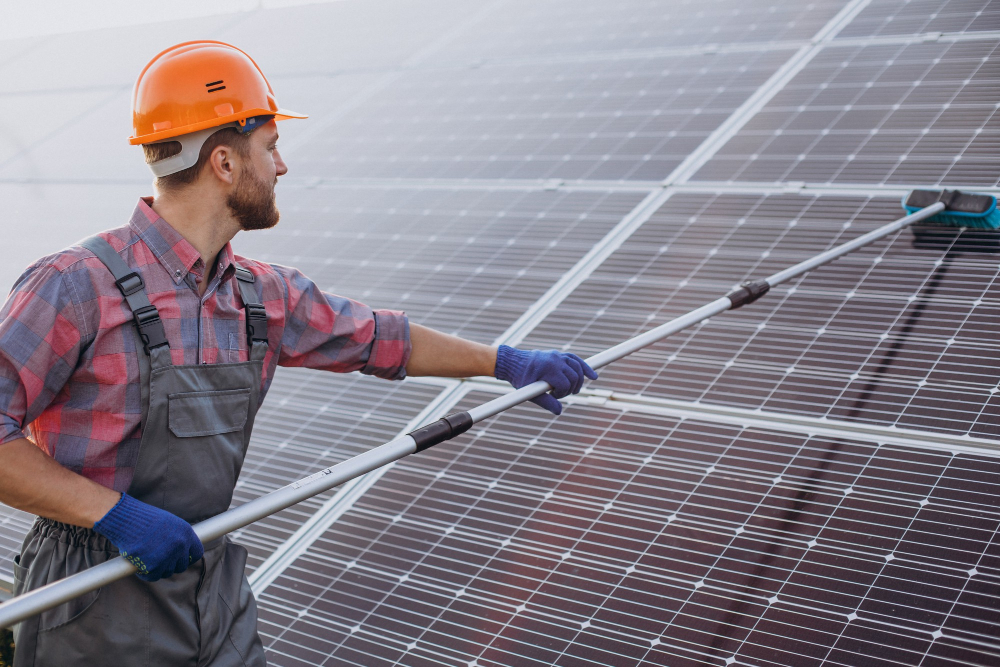 Male Worker Cleaning Solar Panels - Pristine Property Solutions